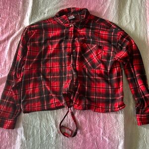 This is a red and black plaid patterned long sleeve. The shirt is also cropped